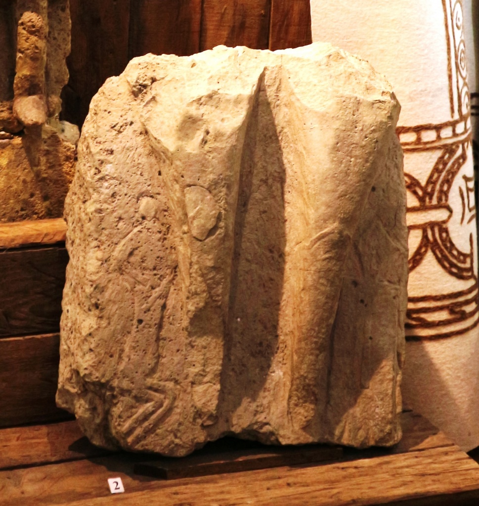 Фрагмент каменного изваяния (нижняя часть) с изображением человечка и музыкального инструмента. Половцы, кон. XI-XII вв. 
